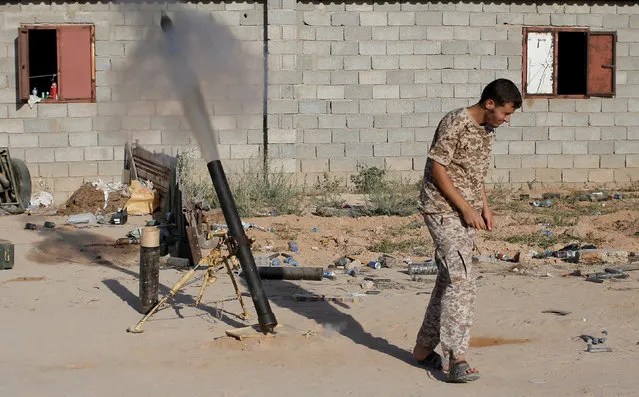 A fighter of Libyan forces allied with the U.N.-backed government fires a 81 mm mortar round in Sirte, Libya, July 26, 2016. (Photo by Goran Tomasevic/Reuters)