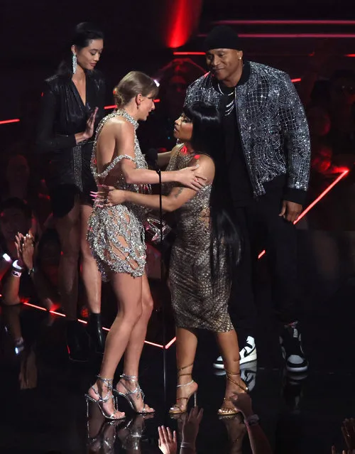 Taylor Swift is greeted by presenter Nicki Minaj as she accepts the award for Video of the Year for “All Too Well” as fellow presenter LL Cool J (R) looks on at the 2022 MTV Video Music Awards at the Prudential Center in Newark, New Jersey, U.S., August 28, 202. (Photo by Brendan McDermid/Reuters)