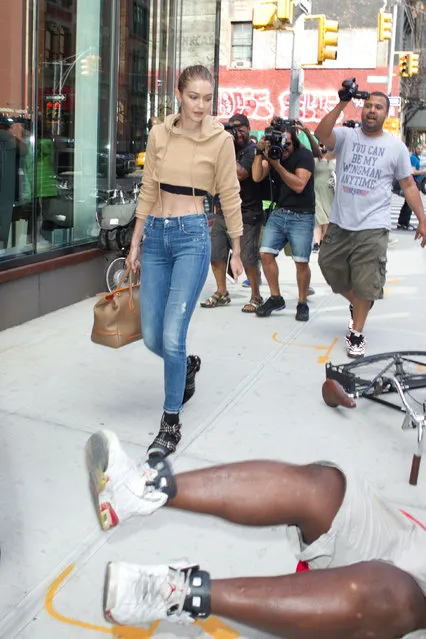 Photographer stumbles and falls while trying to take pictures of Gigi Hadid as she leaves her apartment in New York, NY on July 26, 2016. (Photo by Freddie Baez/Startraksphoto.com)