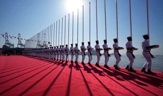 Pakistan Naval soldiers carry national flags of participating countries arrive during the opening ceremony of the five-day multinational exercise hosted by Pakistan's Navy, in Karachi, Pakistan, Friday, February 7, 2025. (Photo by Fareed Khan/AP Photo)