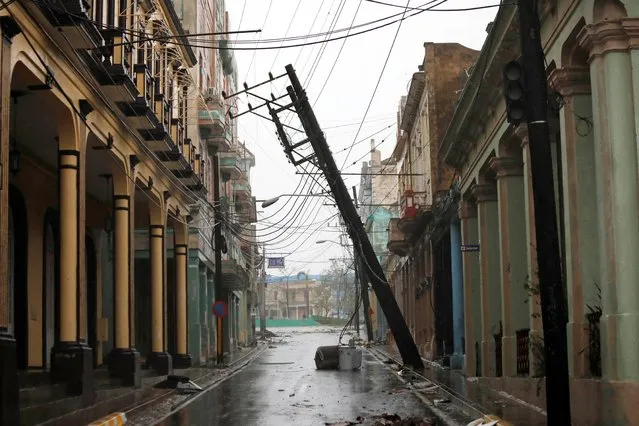 A downed pole is seen on the street in the aftermath of Hurricane Ian's passage through Pinar del Rio, Cuba on September 27, 2022. (Photo by Alexandre Meneghini/Reuters)