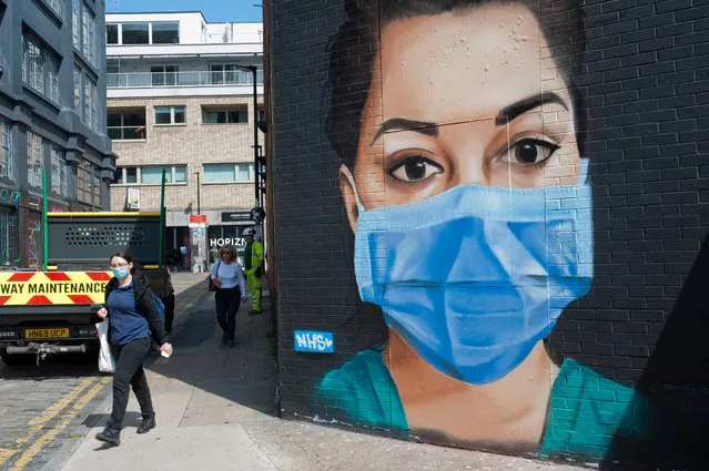 A mural by Graffiti _Life of an NHS worker in a face mask in Shoreditch, England on May 7, 2020. (Photo by Jill Mead/The Guardian)