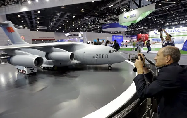 A foreign visitor takes a photo of a model of Y-20 military transporter aircraft at Aviation Industry Corporation of China (AVIC)'s booth at the Aviation Expo China 2015, in Beijing, China, September 16, 2015. The four-day Aviation Expo China 2015 kicked off on Wednesday. According to local media, the expo is jointly organized by Aviation Industry Corporation of China (AVIC), Commercial Aircraft Corporation of China Ltd. (COMAC) and etc. Around 150 exhibitors from 16 countries were invited. (Photo by Jason Lee/Reuters)