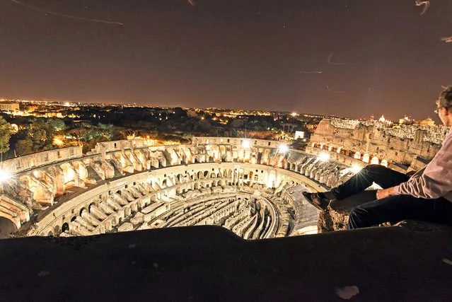 A man climbs up to the top of the Colossuem in Rome, Italy on May 5, 2016. The world-famous colosseum in Rome is once again the site of daredevil bravery. Flavius Vasily, from Kassel,Germany, scrambled over the fence under the cover of darkness to sneak past security. Once inside, he took his own tour of the ancient gladiatorial arena and photographed its majestic beauty at night. Flavius, 23, and a friend only had one shot to make the stunt work - they had a one day layover in Rome before flying on to South Africa and Thailand. (Photo by Flavius Vasily/Caters News Agency)