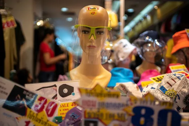 A mannequin wearing a face shield is pictured at a shop inside the Sampheng wholesale market as Thai government eases isolation measures, following the coronavirus disease (COVID-19) outbreak, in Bangkok, Thailand, June 10, 2020. (Photo by Athit Perawongmetha/Reuters)