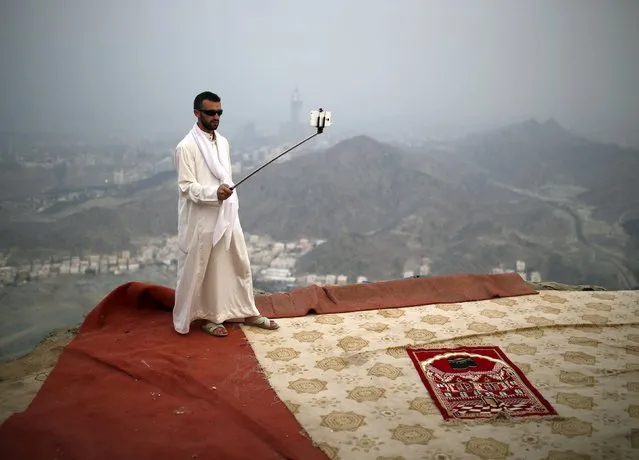 A Muslim pilgrim uses a selfie stick to take pictures atop Mount Thor in the holy city of Mecca ahead of the annual haj pilgrimage September 19, 2015. (Photo by Ahmad Masood/Reuters)