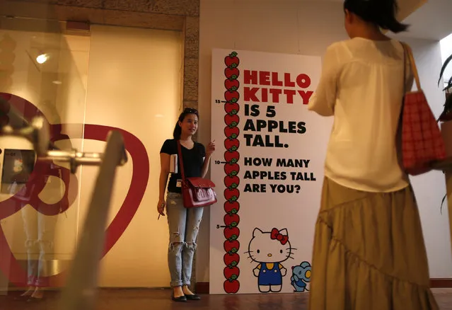 A woman poses for a photo at the “Hello! Exploring the Supercute World of Hello Kitty” museum exhibit in honor of Hello Kitty's 40th anniversary, at the Japanese American National Museum in Los Angeles, California October 10, 2014. (Photo by Lucy Nicholson/Reuters)