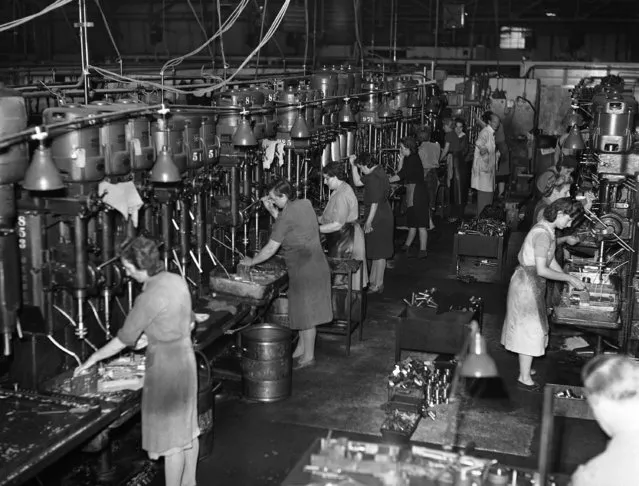 A row of women workers handling B 13 drills, and all of them are working on the Oerlikon main mechanism, at an armaments factory somewhere in England on October 12, 1943. (Photo by AP Photo)