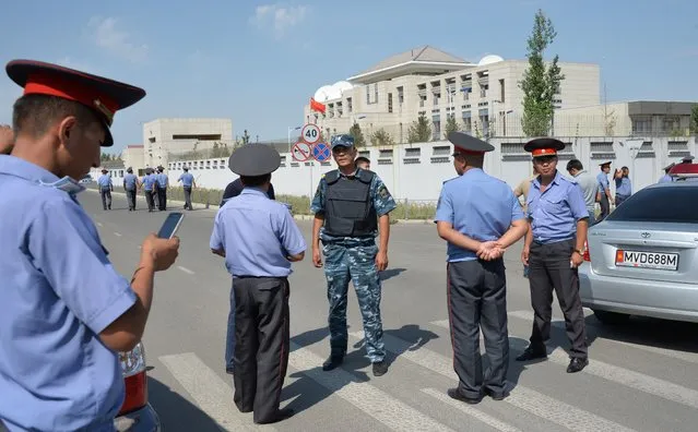 Kyrgyz police officers gather outside the Chinese embassy in Bishkek on August 30, 2016. A van driven by a suicide bomber exploded after ramming through a gate at the Chinese embassy in Kyrgyzstan on August 30, wounding three people, authorities said. (Photo by Vyacheslav Oseledko/AFP Photo)