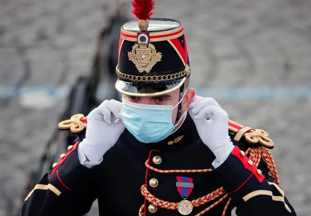 A French soldier adjusts his mask during the Bastille Day celebrations on Place de la Concorde in Paris, France, July 14, 2020. (Photo by Benoit Tessier/Reuters)