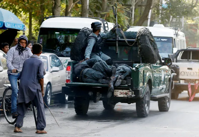Injured policemen are transported at the back of a police vehicle after a suicide attack in Kabul, Afghanistan September 5, 2016. (Photo by Mohammad Ismail/Reuters)