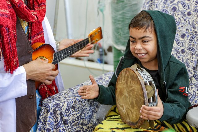 A boy hooked to a dialysis machine beats a tambourine as members of the Gaza Circus School relief team perform around him at the Abdelaziz al-Rantisi Paediatric Hospital in Gaza City, April 15, 2025. (Photo by Omar Al-Qattaa/AFP Photo)