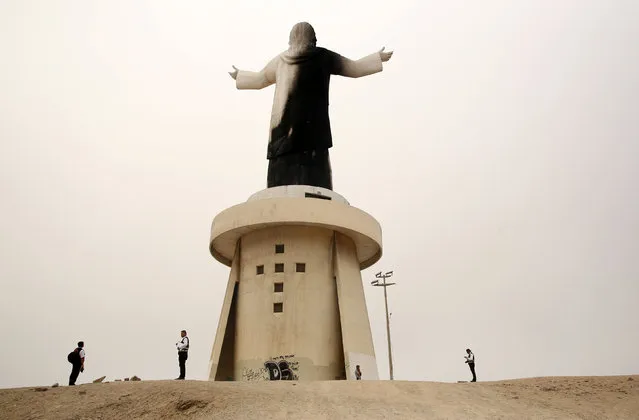 Police investigate near the statue of 'Christ of the Pacific' that was partially burned after a fire at the base of the monument, at Morro Solar hill in Chorrillos, Lima, Peru, January 13, 2018. (Photo by Mariana Bazo/Reuters)