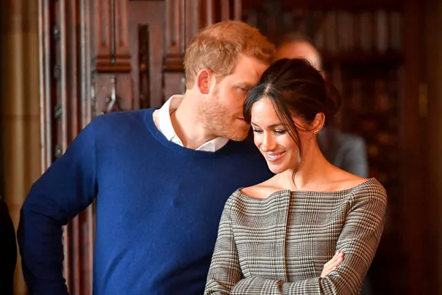 Britain's Prince Harry whispers to Meghan Markle as they watch a performance by a Welsh choir in the banqueting hall during a visit to Cardiff Castle in Cardiff, United Kingdom on January 18, 2018. (Photo by Ben Birchall/Reuters)