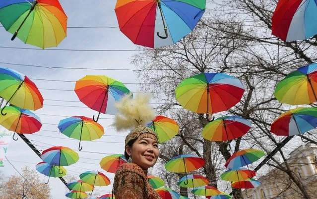 A participant attends a festival marking Nauryz, an ancient holiday celebrating the spring equinox, in Almaty, Kazakhstan on March 21, 2022. (Photo by Pavel Mikheyev/Reuters)