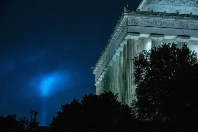 A beam of light is seen near to the Lincoln Memorial, as part of the Towers of Light Tribute marking the 19th anniversary of the 9/11 attack on the Pentagon, Wednesday, September 9, 2020, in Washington. (Photo by Jose Luis Magana/AP Photo)
