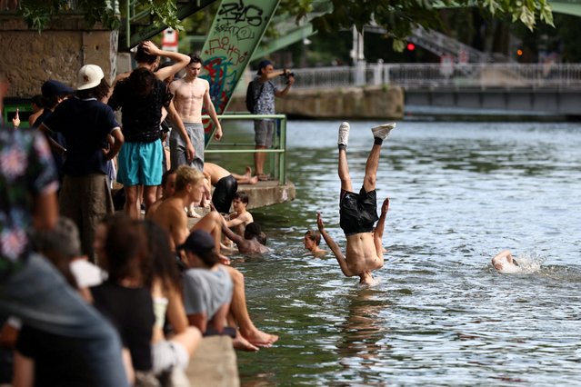 Young people jump into the Canal Saint-Martin on a sunny and warm summer day in Paris as an early summer heatwave hits France, on July 2, 2025. (Photo by Tom Nicholson/Reuters)