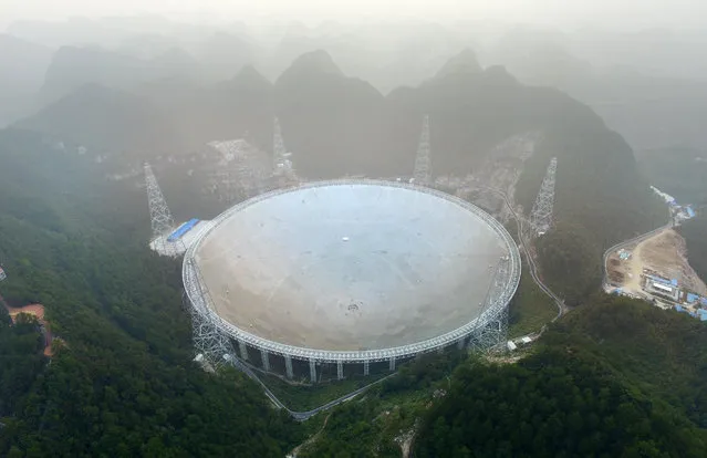 The Five-hundred-metre Aperture Spherical Radio Telescope (FAST) is seen on its first day of operation in Pingtang, in southwestern China's Guizhou province on September 25, 2016. The world's largest radio telescope began operating in southwestern China on September 25, a project which Beijing says will help humanity search for alien life. (Photo by AFP Photo/Stringer)