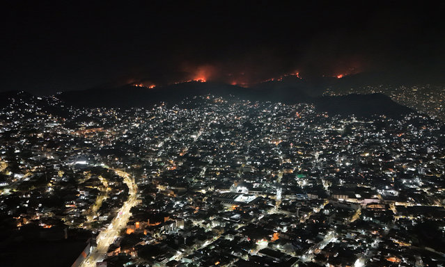A general view shows a fire in El Veladero National Park in Acapulco, Mexico, 25 April 2024. School classes have been suspended due to the thick smoke reaching the area of Acapulco Spa. (Photo by David Guzman/EPA/EFE)