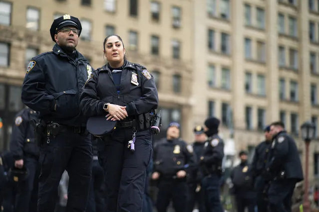 New York Police officers wait for instructions around the courthouse ahead of former President Donald Trump's anticipated indictment on Wednesday, March 22, 2023, in New York. A New York grand jury investigating Trump over a hush money payment to a p*rn star appears poised to complete its work soon as law enforcement officials make preparations for possible unrest in the event of an indictment. (Photo by Eduardo Munoz Alvarez/AP Photo)