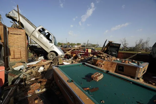 A pickup truck rests on top of a restaurant cooler at Chuck's Dairy Cafe in Rolling Fork, Miss., Saturday, March 25, 2023. .Emergency officials in Mississippi say several people have been killed by tornadoes that tore through the state on Friday night, destroying buildings and knocking out power as severe weather produced hail the size of golf balls moved through several southern states. (Photo by Rogelio V. Solis/AP Photo)