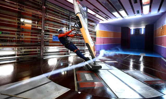 French windsurfer Antoine Albeau stands on his board as he performs tests in a wind tunnel to study aerodynamic phenomena at high speed in Saint-Cyr-l'Ecole, near Paris, on December 7, 2020. 25 times world champion Antoine Albeau's goal is to beat the world speed record in sailing by reaching 121,1 km/h in windsurfing. (Photo by Franck Fife/AFP Photo)