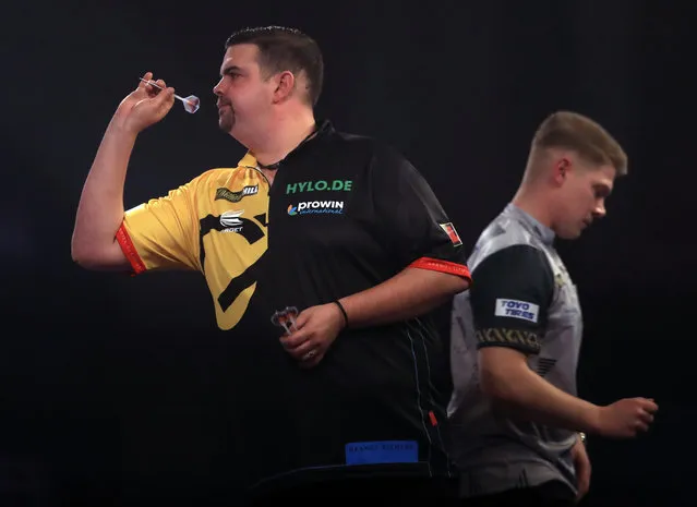 Gabriel Clemens (left) and Nico Kurz (right) during day seven of the William Hill World Darts Championship at Alexandra Palace, London on December 21, 2020. (Photo by Adam Davy/PA Images via Getty Images)