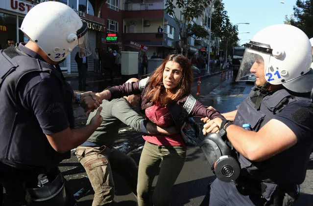 Riot police detain a demonstrator during a protest against the arrest of the city's popular two joint mayors for alleged links to terrorism, in the Kurdish-dominated southeastern city of Diyarbakir, Turkey, October 26, 2016. (Photo by Sertac Kayar/Reuters)