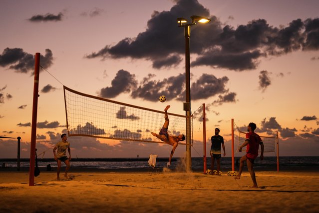 Beachgoers play soccer volleyball next to the Mediterranean sea, in Tel Aviv, Israel, Sunday, October 12, 2025. (Photo by Francisco Seco/AP Photo)