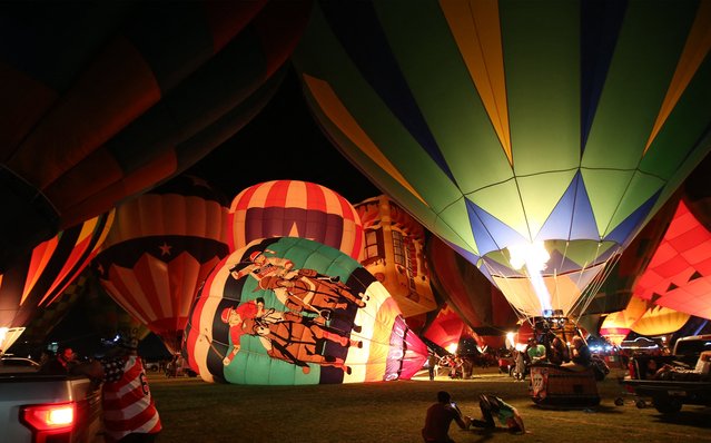 This view shows giant hot air balloons being inflated during the 2025 International Balloon Festival (FIG) in Leon, Mexico on November 14, 2025. (Photo by Mario Armas/AFP Photo)