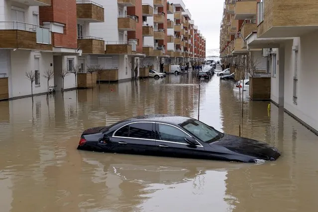 A car is submerged in flood water in the town of Fushe Kosove, Kosovo, 11 January 2021. Due to heavy rain showers many areas wer​e flooded across Kosovo. (Photo by Valdrin Xhemaj/EPA/EFE)