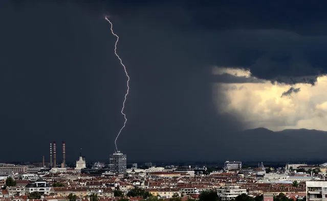 A streak of lightning over a building during a powerful storm in Sofia, Bulgaria, 17 August 2015. (Photo by Vassil Donev/EPA)