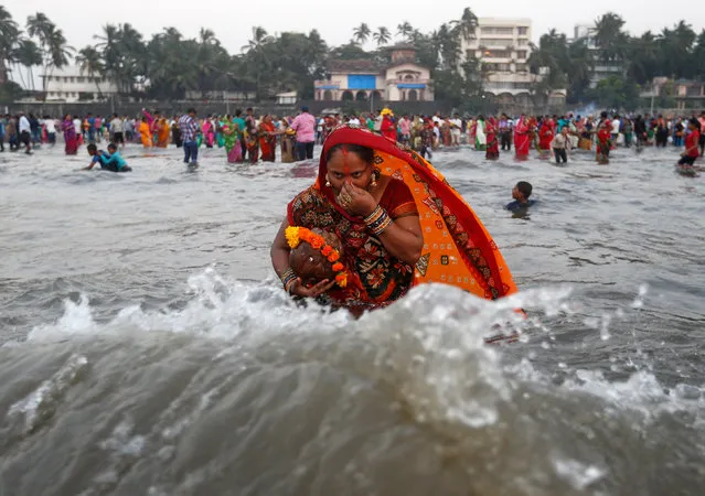 A Hindu devotee takes a dip as she worships the Sun god in the waters of the Arabian Sea during Chhath Puja in Mumbai, India November 6, 2016. (Photo by Danish Siddiqui/Reuters)