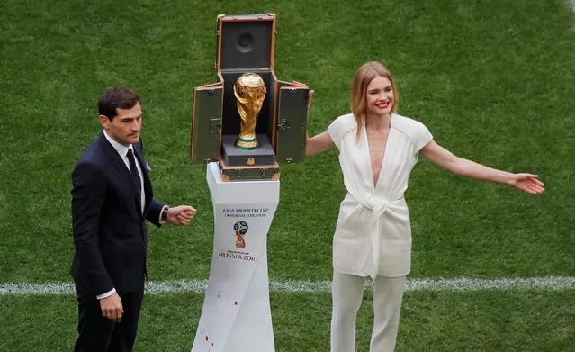 Russian model Natalia Vodianova (R) and Spanish goalkeeper Iker Casillas stand next to the World Cup trophy during the opening ceremony before the Russia 2018 World Cup Group A football match between Russia and Saudi Arabia at the Luzhniki Stadium in Moscow on June 14, 2018. (Photo by Maxim Shemetov/Reuters)