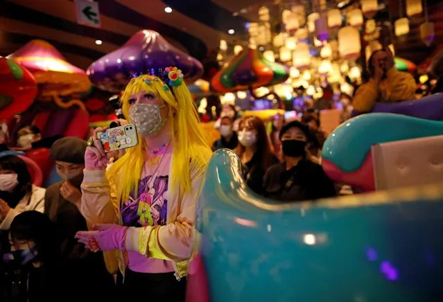 Guests watch the performance by the staff members of Kawaii Monster Cafe called “Monster Girls” before the cafe ends its five-year run operation on the day, amid the coronavirus disease (COVID-19) outbreak, in Tokyo,  Japan on January 31, 2021. While Sebastian Masuda, the artist who designed the sprawling cafe, said he was sad to see it close, he remained upbeat on the future of the trend-setting district. “In Harajuku, regardless of age and era, the younger generations will always create new cultures. So I believe that the young generation will make something interesting again”. (Photo by Issei Kato/Reuters)
