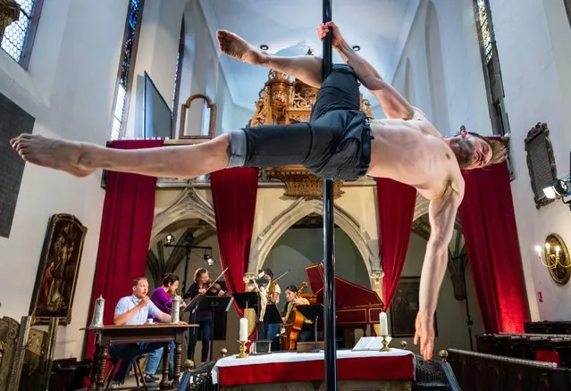 French pole dancer Vincent Grobelny performs during a rehearsal of the opera “La serva Padrona” by Pergolesi at the Protestant church of Saint-Guillaume, in Strasbourg, eastern France, on May 28, 2023. This liberal and inclusive Protestant parish refuses to give in to “obscurantism” and death threats aimed at its pastor after a show combining sacred music and pole dancing in his church. In the past, the rich cultural program of the Saint-Guillaume church already sparked some criticism when it hosted “The 12 drag queens”, a cabaret of drag queens. (Photo by Patrick Hertzog/AFP Photo)