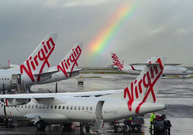 A rainbow from a passing rain shower sits over Virgin Australia aircraft at Sydney's Airport in Australia, August 5, 2016. (Photo by Jason Reed/Reuters)