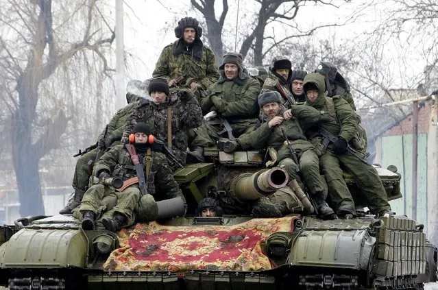 Members of the armed forces of the separatist self-proclaimed Donetsk People's Republic drive a tank on the outskirts of Donetsk January 22, 2015. (Photo by Alexander Ermochenko/Reuters)