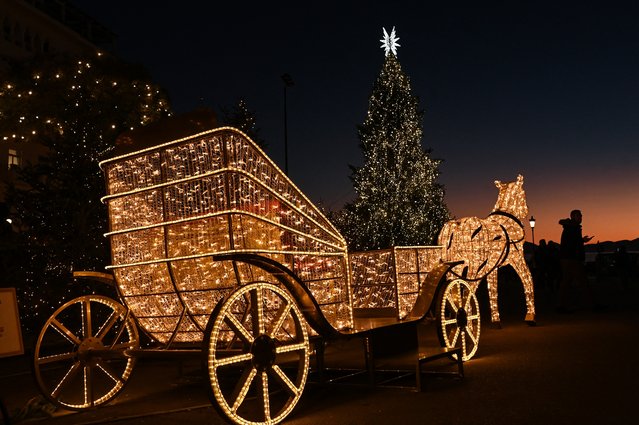 This photograph taken on December 17, 2024, shows Christmas trees and decorations illuminated in Thessaloniki. (Photo by Sakis Mitrolidis/AFP Photo)