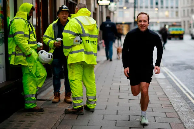 Britain's Health Secretary Matt Hancock poses running past photographers whilst out for a morning jog in Westminster central London on December 4, 2020. (Photo by Tolga Akmen/AFP Photo)