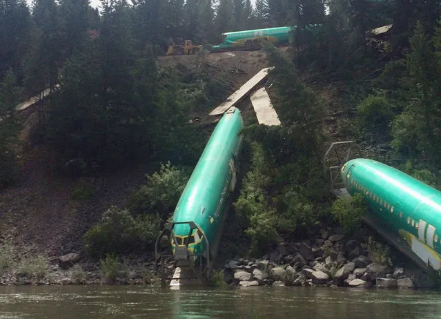 Three Boeing 737 fuselages lie on an embankment on the Clark Fork River after a Burlington Northern Santa Fe (BNSF) Railway Co train derailed near Rivulet, Montana July 4, 2014. The train carried six 737 narrow-body fuselages and assemblies for Boeing's 777 and 747 wide-body jets. Three of the fuselages went into the Clark Fork River. (Photo by Andrew Spayth/Reuters)