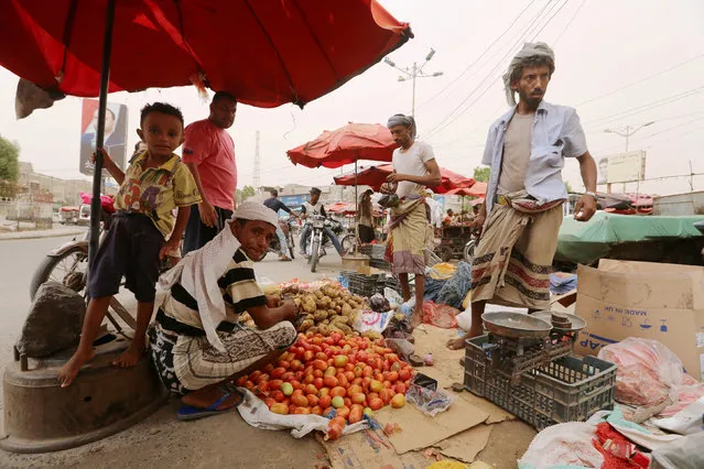 A street vendor sells vegetables in the Red Sea port city of Hodeidah, Yemen, June 14, 2018. (Photo by Abduljabbar Zeyad/Reuters)