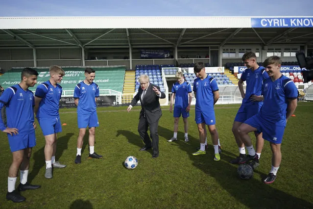 Britain's Prime Minister Boris Johnson speaks with players from the youth team during a visit to the Hartlepool United Football Club, in Hartlepool, England ahead of the May 6 by-election, Friday April 23, 2021. (Photo by Ian Forsyth/Pool via AP Photo)