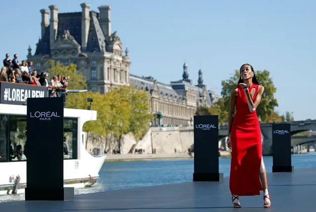 Model Winnie Harlow presents a creation on a giant catwalk installed on a barge on the Seine River during a public event organized by French cosmetics group L'Oreal as part of Paris Fashion Week, France, September 30, 2018. (Photo by Stephane Mahe/Reuters)