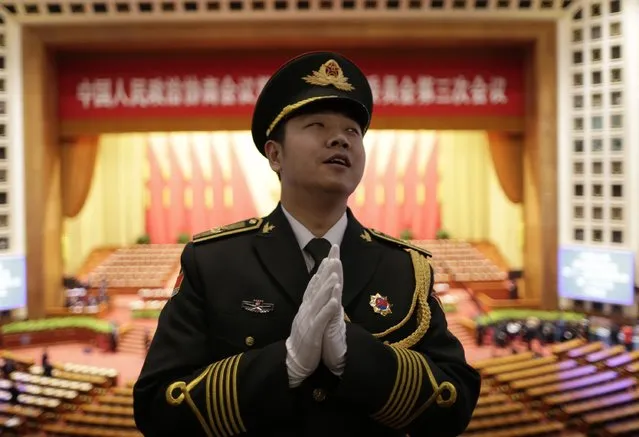 A military band conductor practices during rehearsal ahead of the opening session of Chinese People's Political Consultative Conference (CPPCC) at the Great Hall of the People in Beijing, March 3, 2015. REUTERS/Jason Lee
