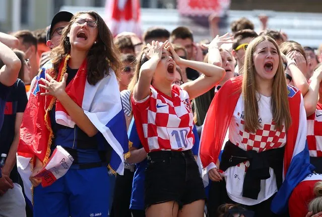 Croatia fans react after England's first goal as they watch a broadcast of the UEFA EURO 2020 football match between England and Croatia at the Jelacic square in Zagreb, on June 13, 2021. (Photo by Antonio Bronic/Reuters)