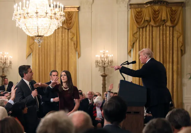 A White House staff member reaches for the microphone held by CNN's Jim Acosta as he questions U.S. President Donald Trump during a news conference following Tuesday's midterm U.S. congressional elections at the White House in Washington, U.S., November 7, 2018. (Photo by Jonathan Ernst/Reuters)