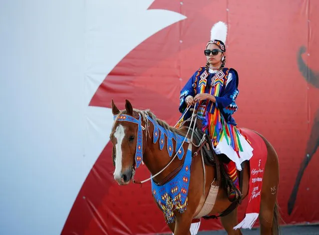 Parade marshall Katari Right Hand rides her horse in the parade as the Calgary Stampede gets underway following a year off due to the coronavirus disease (COVID-19) restrictions, in Calgary, Alberta, Canada on July 9, 2021. (Photo by Todd Korol/Reuters)