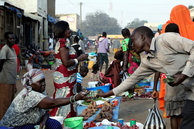 South Sudanese civilians conduct business at the market in Yei, southwest of the capital Juba, South Sudan January 1, 2017. (Photo by Jok Solomun/Reuters)