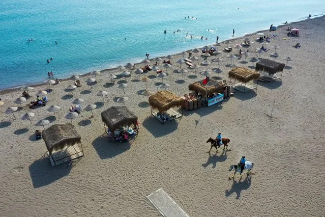 A drone photo shows mounted gendarmerie teams patrolling to provide the security at a beach in Izmir, Turkey on July 13, 2021. (Photo by Mehmet Emin Menguarslan/Anadolu Agency via Getty Images)